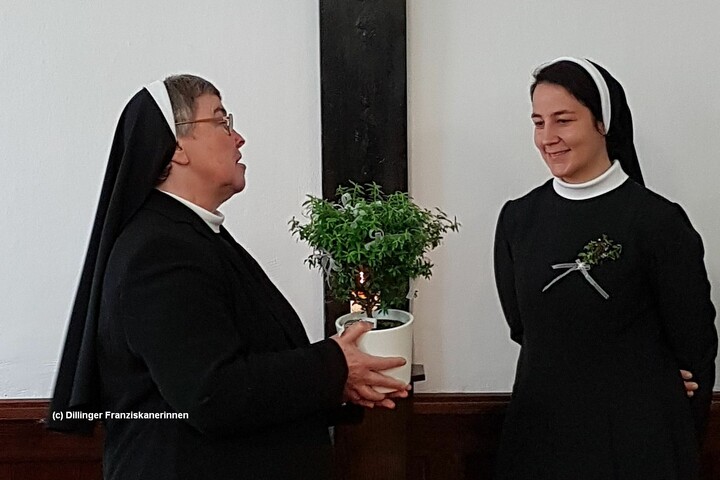 Sr. Elke schenkt Sr. Hannah bei der Gratulation ein Myrthenstöckchen